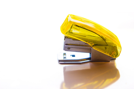 yellow stapler isolated on white backgroundの写真素材