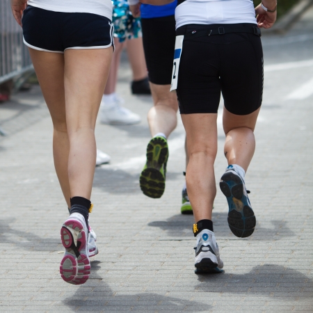 running men at a foot raceの写真素材