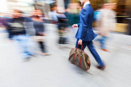 businessman walking in the city in motion blurの写真素材