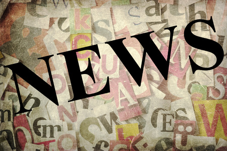 the word news on a background of a collage of cut out lettersの写真素材