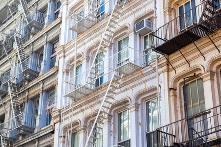 typical old building with fire escape ladders in Soho, Manhattan, New York City