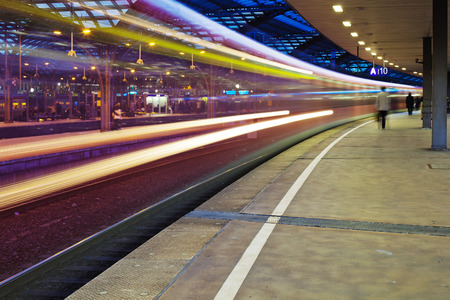 night photo of a departing train at the train station with motion blurのeditorial素材