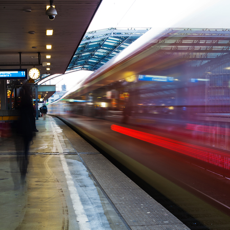 leaving train at dusk in motion blur showing light trailsのeditorial素材