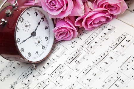 still life with old alarm clock on music sheetsの写真素材