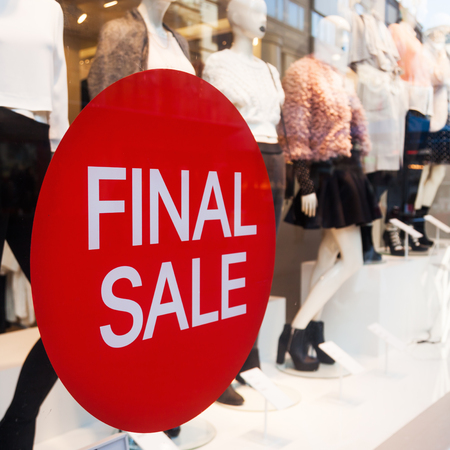 emblem with final sale lettering at a shop window of a clothing storeの写真素材