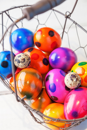 colorful easter eggs in a basketの写真素材