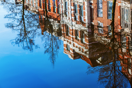 buildings reflects in the water of a canal in The Hague, Netherlands
