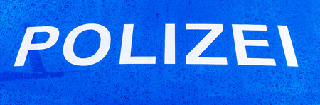 the word police on a wet German police carの写真素材