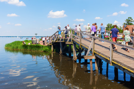 Steinhude, Germany - June 05, 2016: Steinhuder Meer at Steinhude with unidentified people. With about 30 sq km it is the largest lake of northwestern Germany and it is a nationwide tourist destinationのeditorial素材