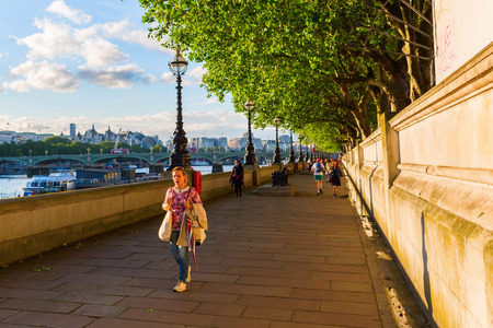 London, UK - June 20, 2016: unidentified people strolling and jogging along the Thames. London is one of the most important cultural, finance and trade cities of the world.のeditorial素材
