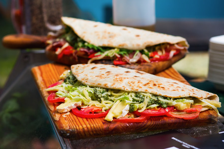 wraps with vegetables and cheese at a street food marketの写真素材