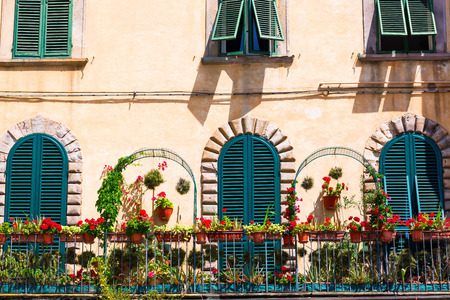 picturesque flower decorated balcony in Lucca, Italyの写真素材