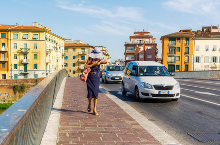 Pisa, Italy - June 30, 2016: bridge over the river Arno in Pisa with unidentified people. Pisa is known worldwide for its leaning tower.のeditorial素材