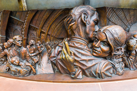 London, UK - June 16, 2016: statue -The Meeting Place- at St. Pancras Station in London. Its a 9m tall bronze statue of an intimate pose by the world renowned sculptor Paul Day.のeditorial素材