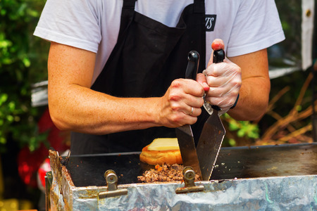 cook prepares food at a street food stall in London, UKの写真素材