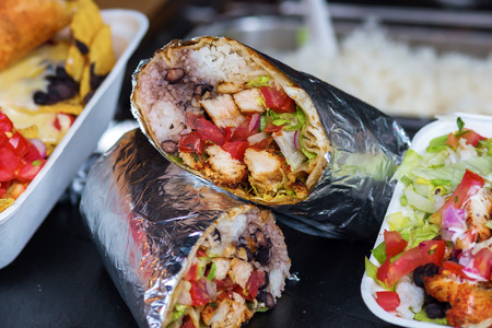wraps wrapped up in tinfoil at a stall of a streeet food marketの写真素材