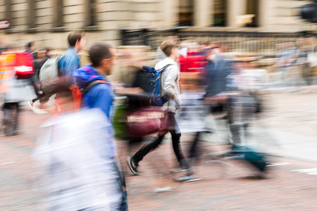 picture with creative zoom effect made by camera of a people crowd crossing a city streetの写真素材