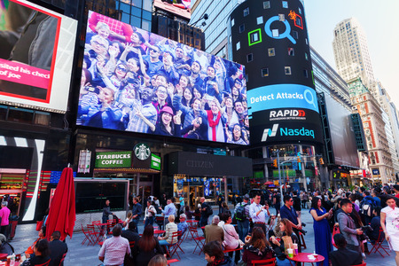 New York City, USA - October 06, 2015: big screen at Times Square with unidentified people. It is...