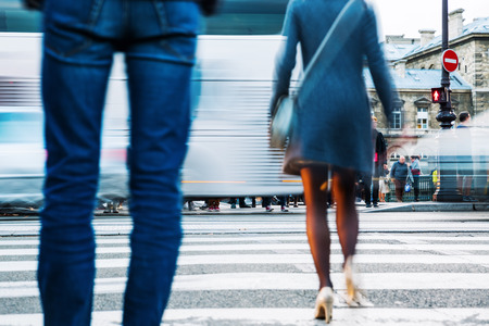 street view at the pedestrian crossing with traffic and people in motion blurの写真素材