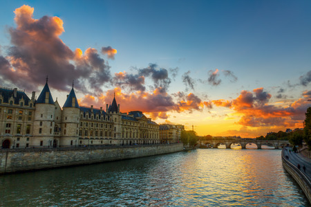 view of the Conciergerie on the Ile de la Cite in Paris, France, at sunsetの写真素材