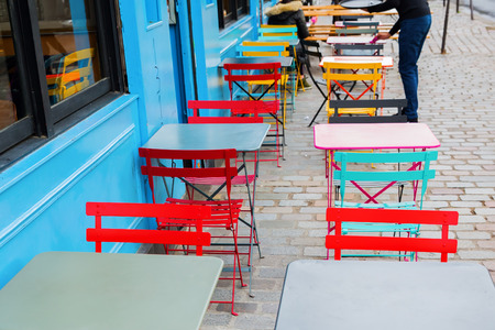 colorful tables and chairs of a street cafe in Paris, Franceの写真素材