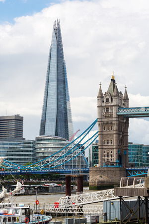 London, UK - June 15, 2016: The Shard and the Tower Bridge in London. London is the capital of England and one of the most important cultural, finance and trade cities of the world.のeditorial素材