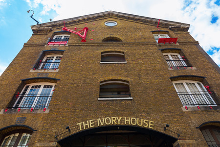 London, UK - June 15, 2016: Ivory House in London from 1858. It is the only original warehouse still standing in St Katharine Docks. Today it houses shops, restaurants and luxury apartmentsのeditorial素材