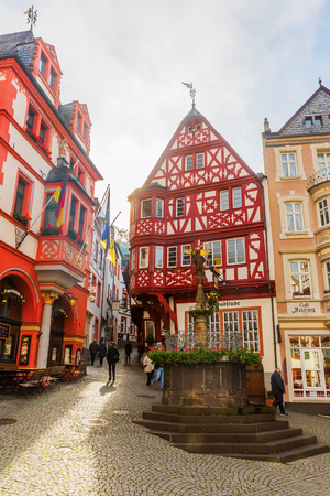 Bernkastel-Kues, Germany - November 01, 2016: medieval market square with unidentified people. Around the St. Michaels fountain are clustering several well preserved buildings from medieval time.のeditorial素材