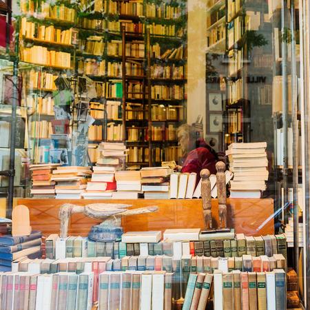 Paris, France - October 17, 2016: unidentified man is sitting in an antiquarian book shop in Paris....