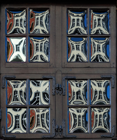 antique crown glass windows at a historical building in Aachen, Germany