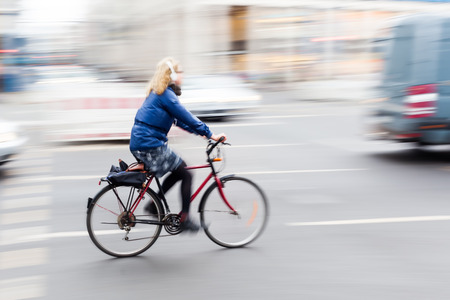 bicycle rider in the city in motion blurの写真素材