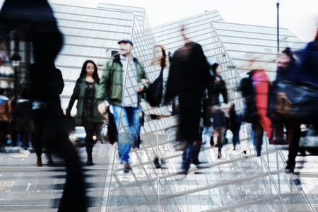 multi exposure image of crowds of people and office buildingsの写真素材