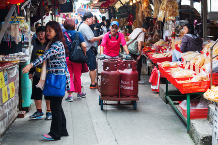 Tai O, Hong Kong - March 13, 2017: street scene with unidentified people in Tai O. Tai O is a popular traditional fishing village on Lantau Island with unique stilt housesのeditorial素材