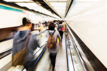 people walking in the passage of an underground station with camera made zoom effectの写真素材