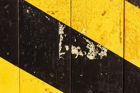 background texture from painted wood with black and yellow diagonal stripesの写真素材