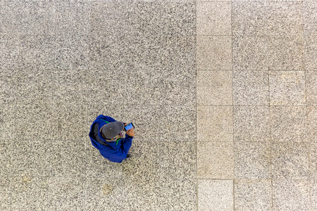 picture of a man with phone seen from aboveの写真素材