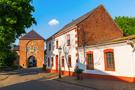 Bedburg, Germany - May 10, 2017: townscape with town gate in Kaster, with unidentified people. Kaster is a district of Bedburg in the Rhein-Erft-Kreis. It is known for its preserved historic townscapeのeditorial素材