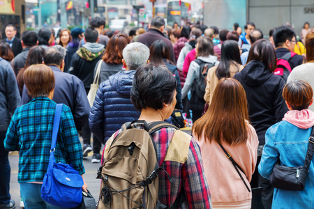 Hong Kong, Hong Kong - March 10, 2017: crowds of unidentified people crossing a road in Hong Kong. HK is one of worlds most significant financial centres and the 4th most densely populated stateのeditorial素材