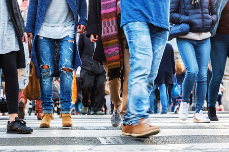 picture of crowds of people in motion blur crossing a city streetの写真素材