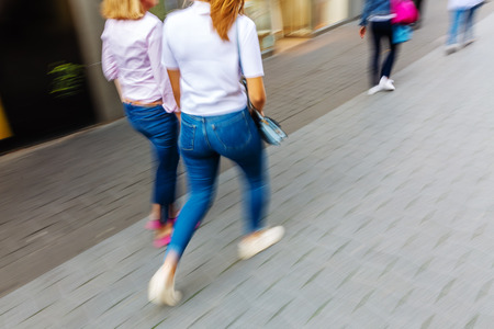 picture with motion blur effect walking in the pedestrian zone of a cityの写真素材
