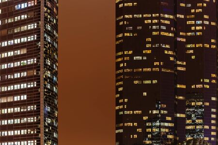 picture of skyscrapers with illuminated windows at nightの写真素材