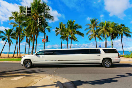Honolulu, Oahu, Hawaii - November 04, 2019: stretch limo at Waikiki beach with unidentified people. Waikiki is a neighbourhood of Honolulu, most famous for Waikiki beach, almost entirely man-madeのeditorial素材