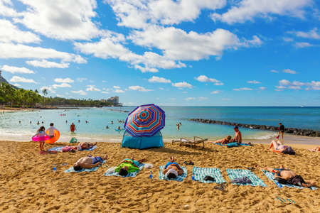 Honolulu, Oahu, Hawaii - November 04, 2019: view of Waikiki beach with unidentified people. Waikiki is a neighbourhood of Honolulu, most famous for Waikiki beach, which is almost entirely man-madeのeditorial素材
