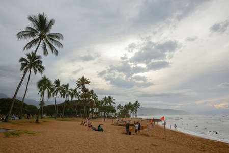 Haleiwa, Hawaii, US - November 06, 2019: beach at dusk with unidentified peoplein Haleiwa. Haleiwa is the largest commercial center at the North Shore and popular destination for surfing and divingのeditorial素材