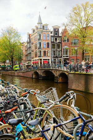 Amsterdam, Netherlands - October 28, 2019: cityscape with typical canal in Amsterdam, with unidentified people. Amsterdam is the capital and most populous city in the Netherlandsのeditorial素材