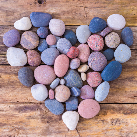 Stone heart on a wooden backgroundの写真素材