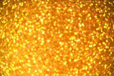 Festive Christmas background with stars. Abstract twinkled bright background with bokeh defocused...