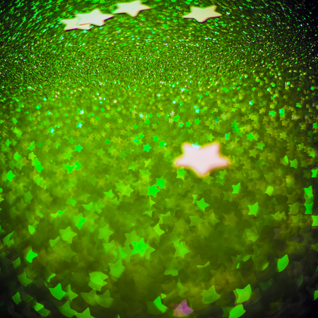 Festive Christmas background with stars. Abstract twinkled bright background with bokeh defocused lightsの写真素材