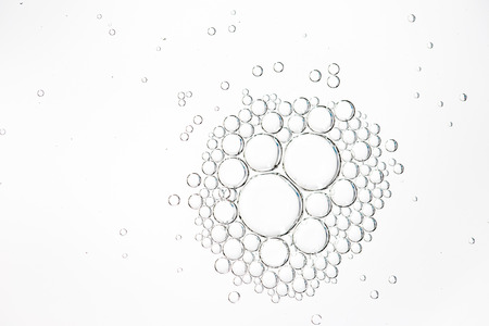Oil drops in water on a white background