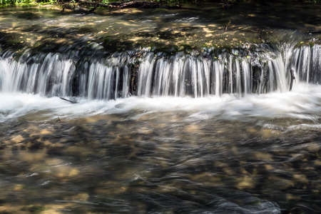 Mountain stream with stones with clear water